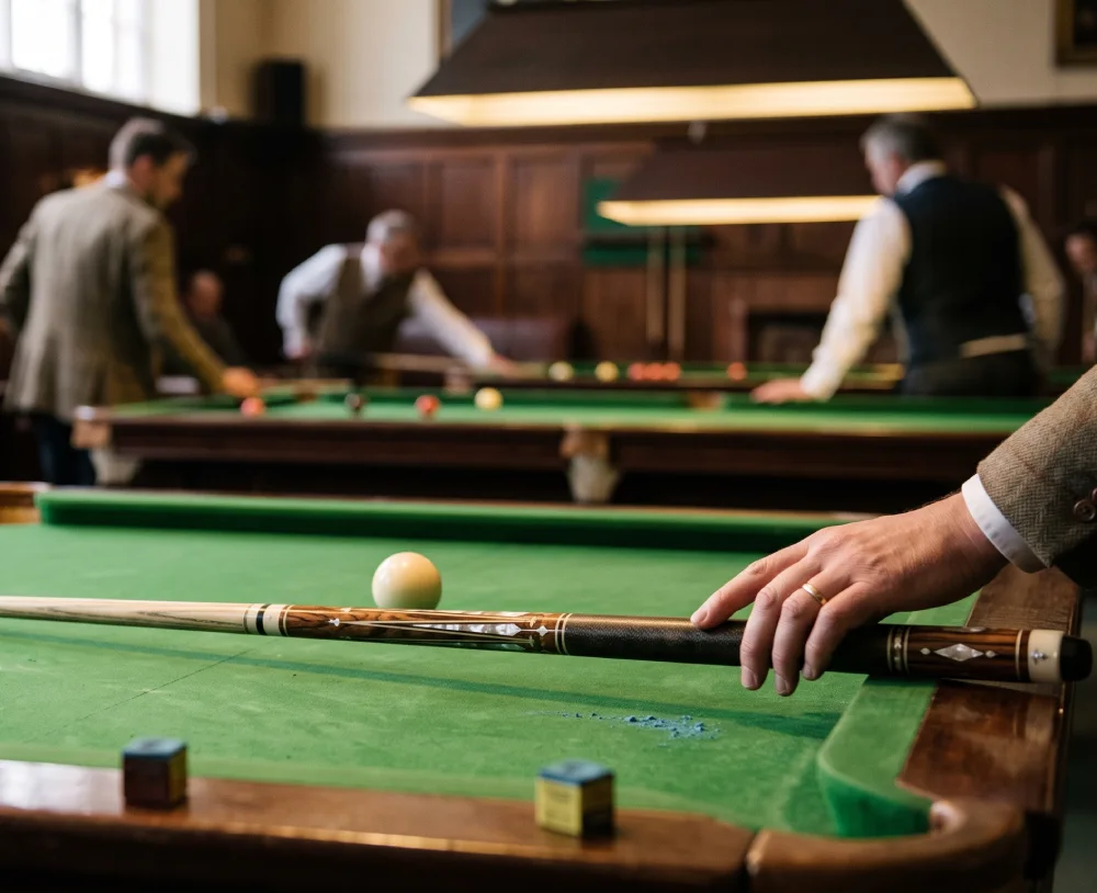 Men playing billiards in hall
